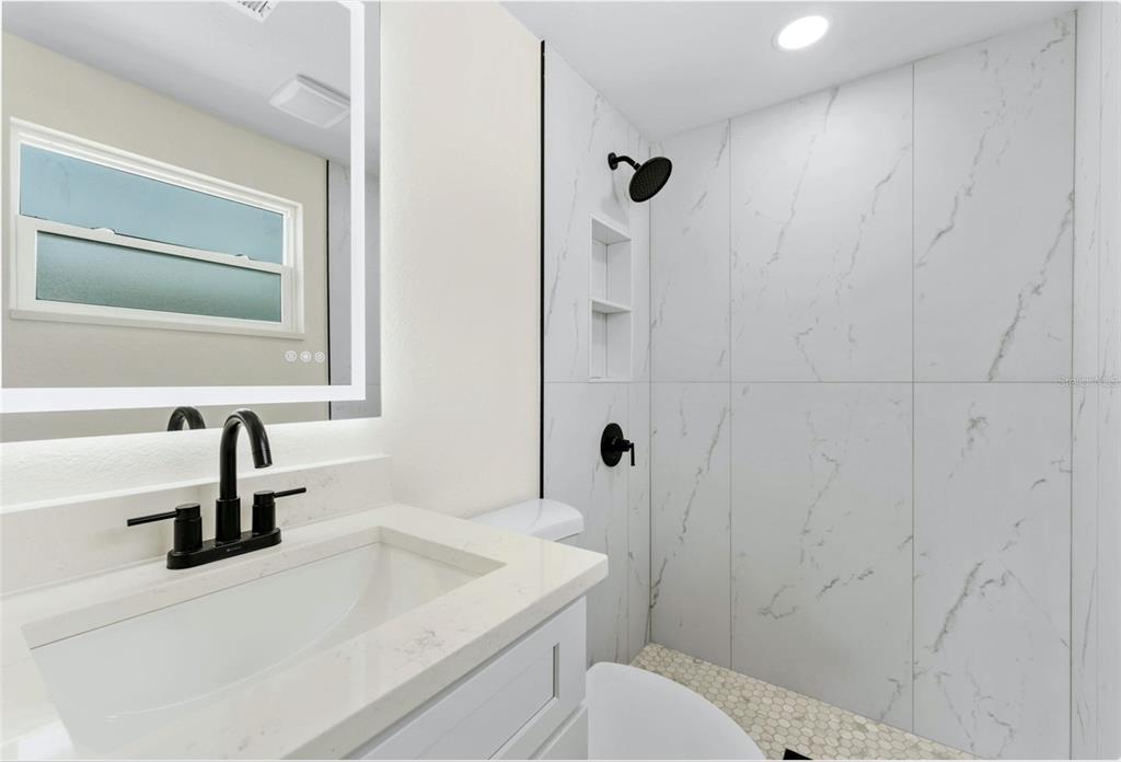 4016 Grayton Drive New Port Richey, FL 34652 - Photo 27 of 40 a bathroom with a sink a toilet and shower