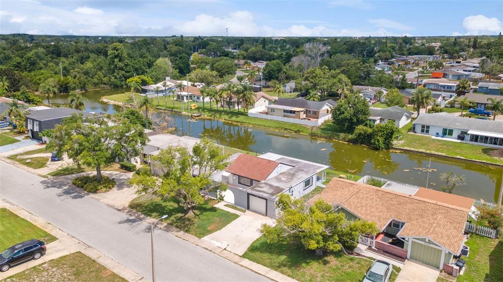 4016 Grayton Drive New Port Richey, FL 34652 - Photo 35 of 40 an aerial view of residential houses with outdoor space and lake view