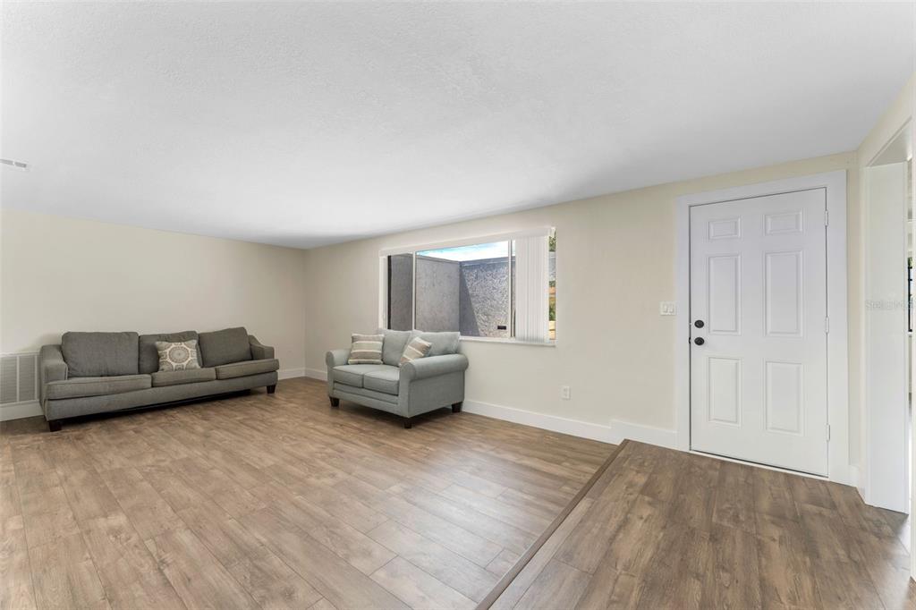 4016 Grayton Drive New Port Richey, FL 34652 - Photo 7 of 40 a living room with furniture and a wooden floor