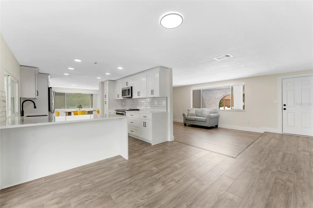 4016 Grayton Drive New Port Richey, FL 34652 - Photo 10 of 40 a living room with furniture and kitchen view