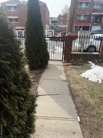 a view of a brick building next to a yard
