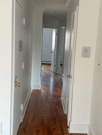 a view of a hallway with wooden floor