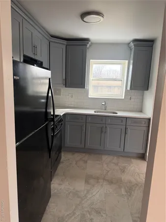 a kitchen with a sink and cabinets