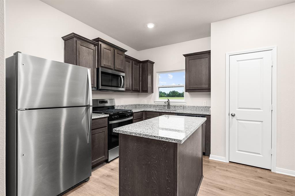 201 North Island Drive Terrell, TX 75160 - Photo 3 of 5 a kitchen with stainless steel appliances granite countertop a refrigerator a microwave a sink and a stove