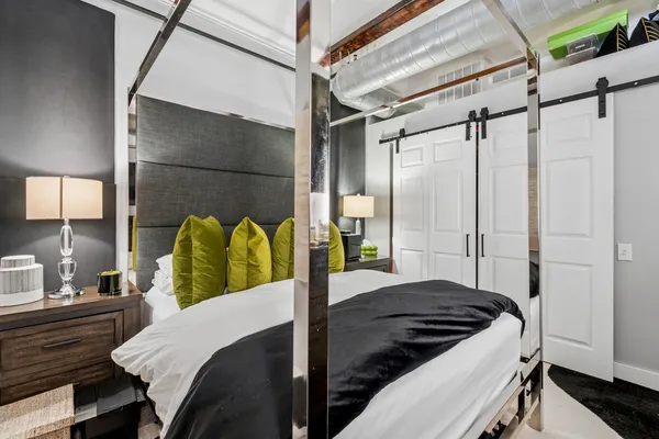 a bedroom with a bed dresser and a window