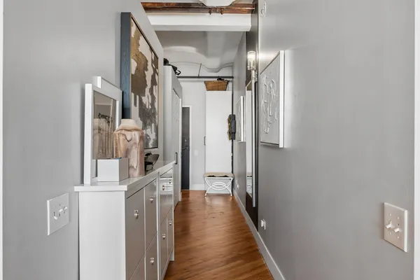 a view of hallway with wooden floor