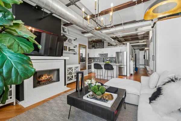 a living room with furniture and a fireplace