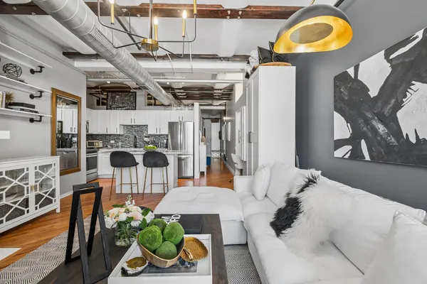 a living room with lots of furniture and a wooden floor