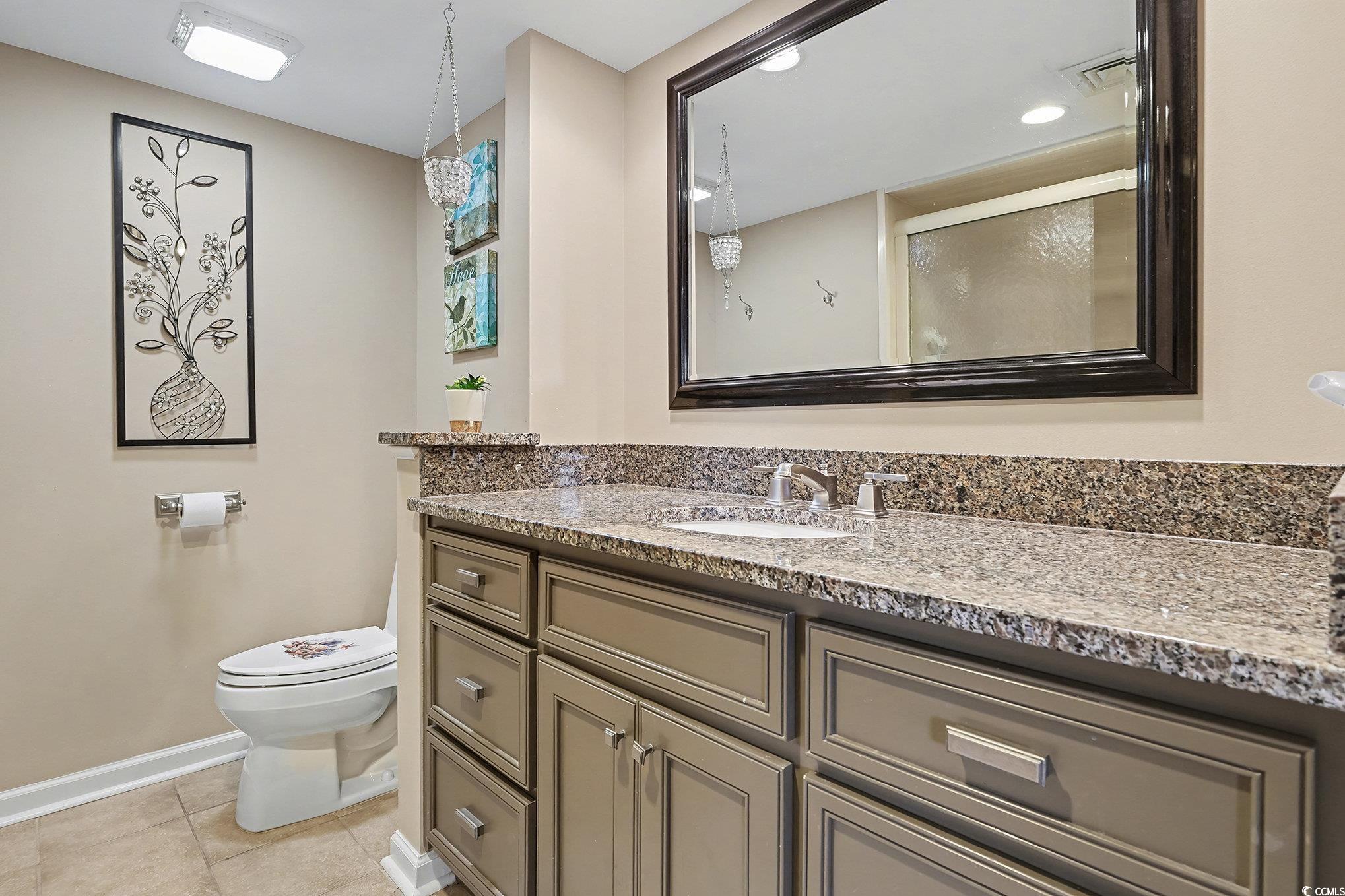 9650 Shore Drive, Unit 1507 Myrtle Beach, SC 29572 - Photo 14 of 39 Full bath featuring vanity, light tile patterned flooring, and a shower with shower door