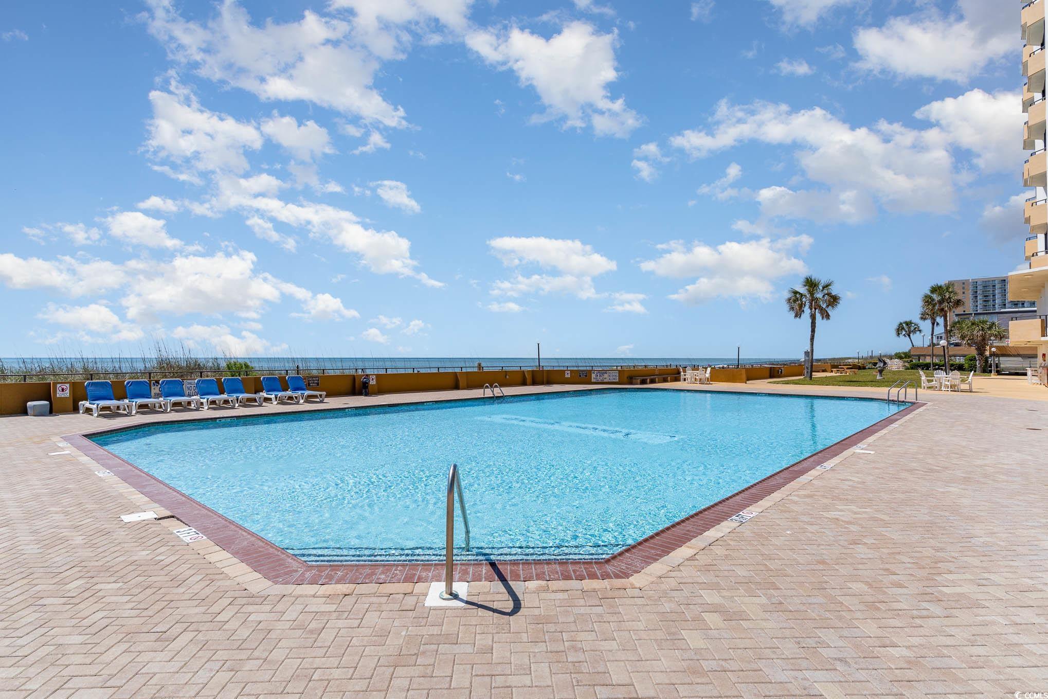 9650 Shore Drive, Unit 1507 Myrtle Beach, SC 29572 - Photo 31 of 39 Community pool featuring a patio area