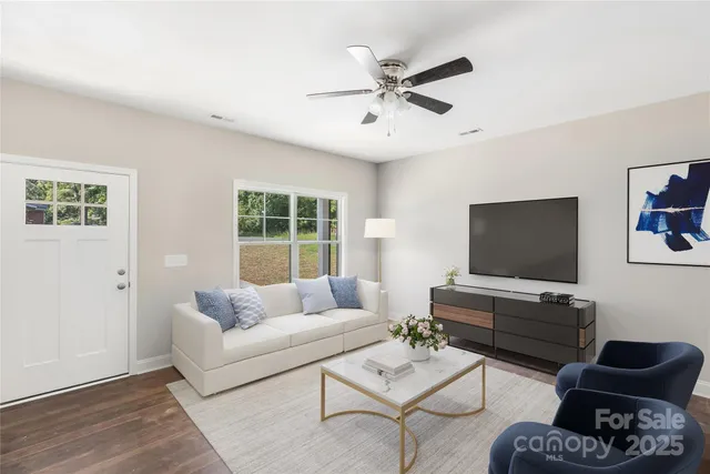 a living room with furniture and a flat screen tv