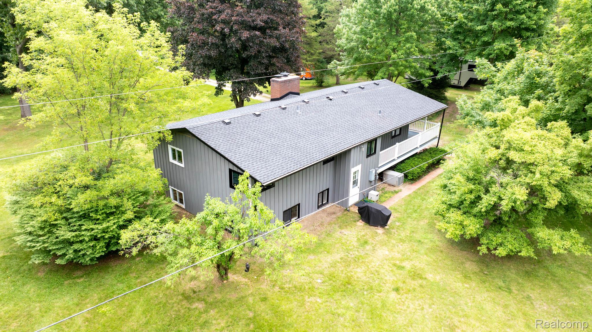 7333 Toma Road Dexter, MI 48130 - Photo 10 of 45 Contemporary residence featuring gray vertical siding and a dark shingle roof