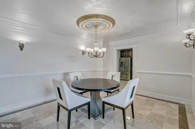 a view of a dining room with furniture and chandelier