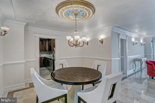 a living room with furniture and kitchen view