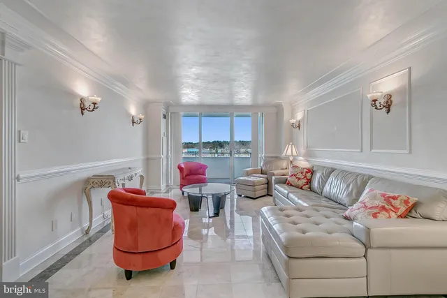 a view of a hallway and a livingroom with furniture