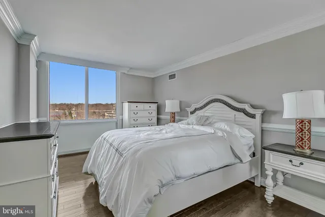 a bedroom with a bed and a lamp on table
