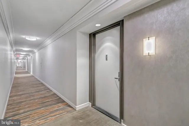 a view of a hallway with wooden floor