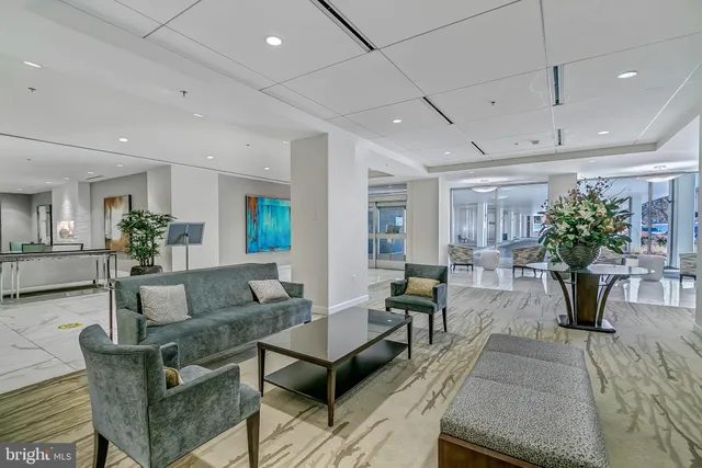 a living room with furniture potted plant and a table