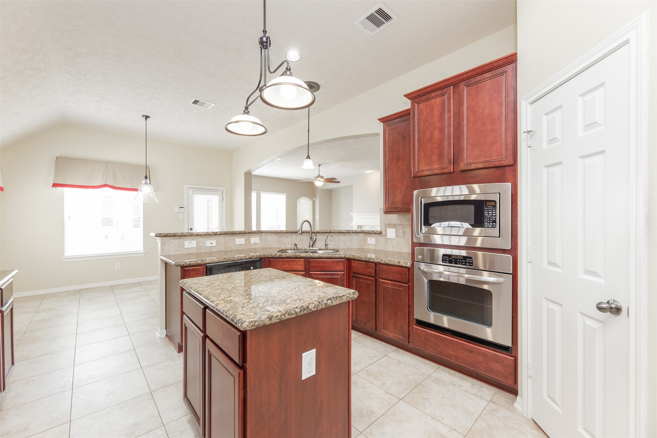 25919 Pebble Terrane Lane Katy, TX 77494 - Photo 15 of 28 a kitchen with stainless steel appliances granite countertop a sink and a stove