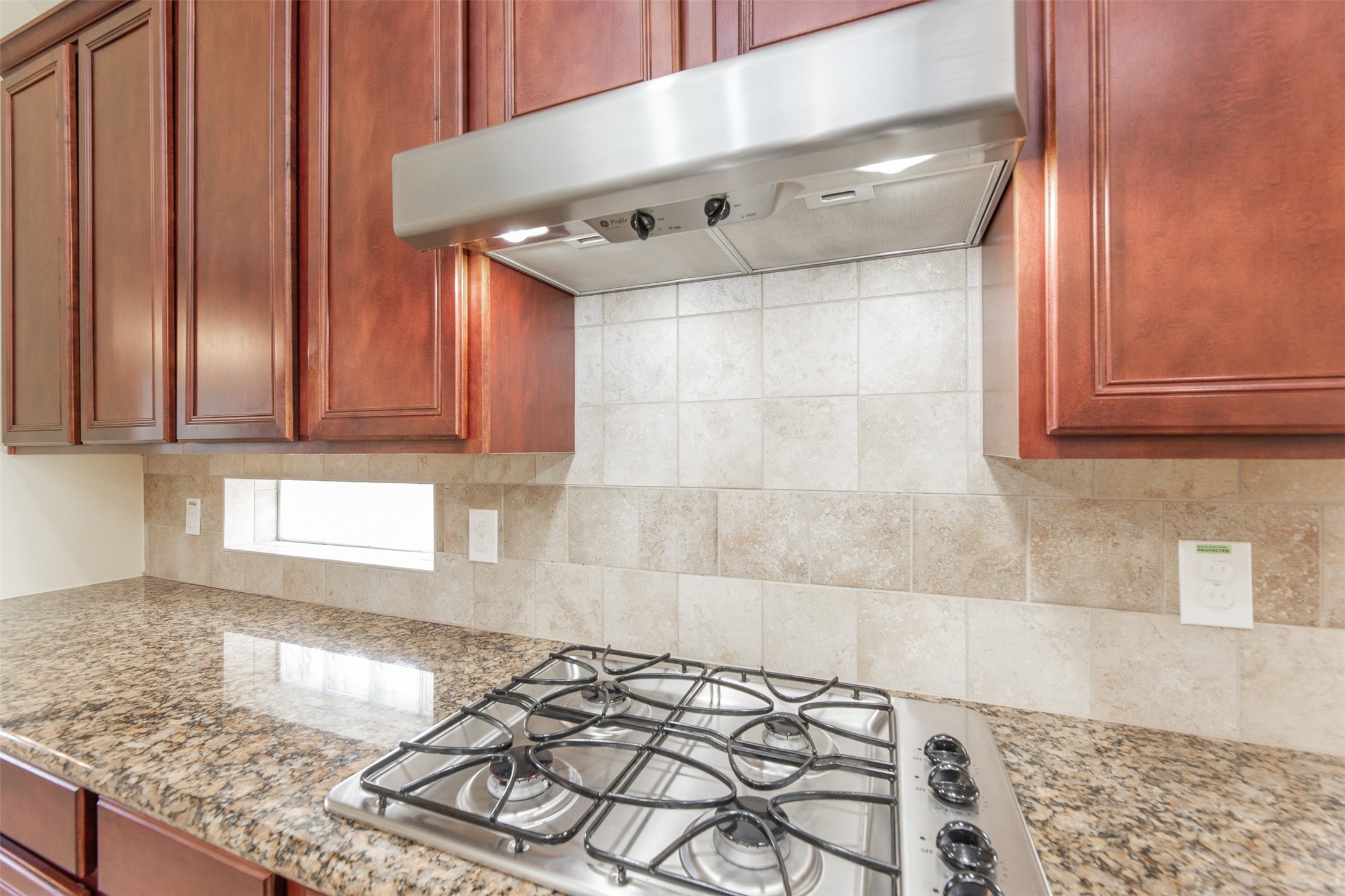 25919 Pebble Terrane Lane Katy, TX 77494 - Photo 16 of 28 a kitchen with granite countertop wooden cabinets and a counter top space