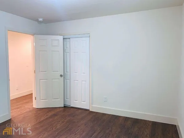 an empty room with wooden floor