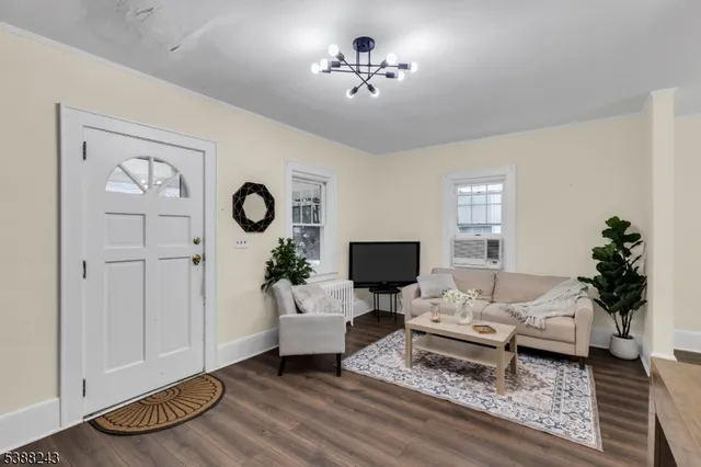 a living room with furniture a rug and a window