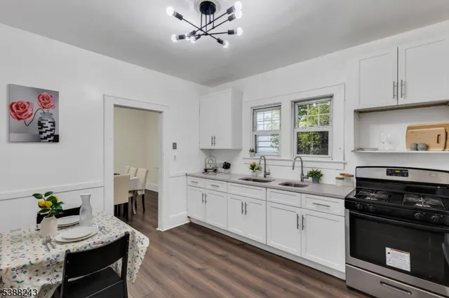 a kitchen with stainless steel appliances white cabinets and a window