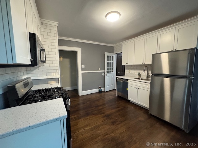 463 Highland Avenue Stratford, CT 06614 - Photo 2 of 14 a kitchen with a refrigerator a sink and white cabinets