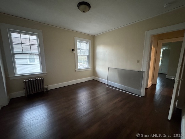 463 Highland Avenue Stratford, CT 06614 - Photo 5 of 14 an empty room with wooden floor and windows