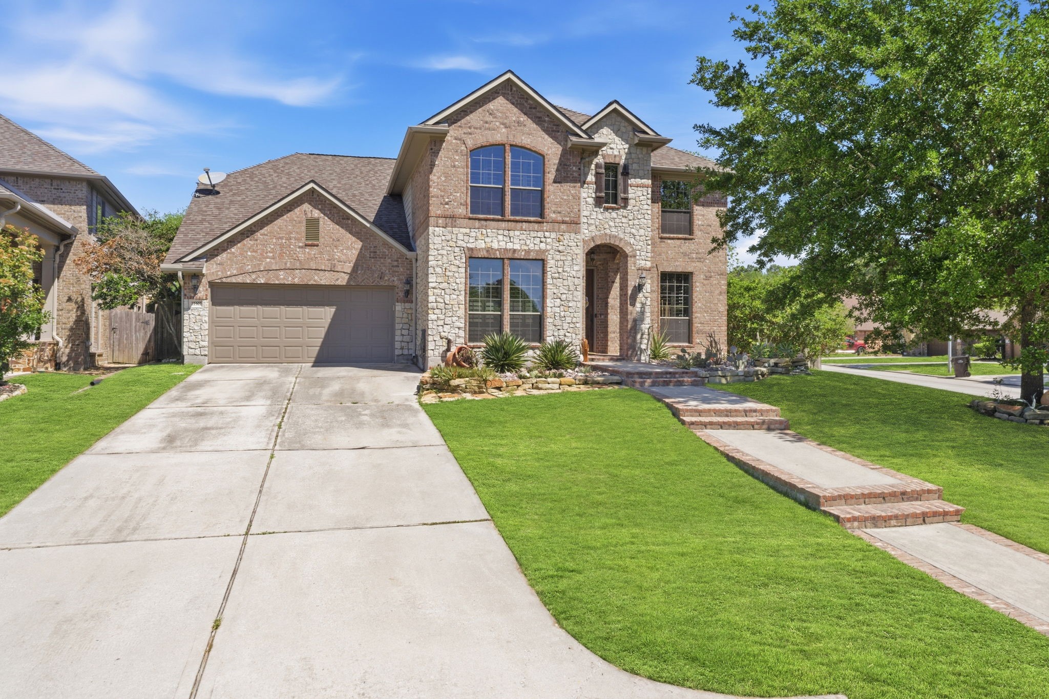 a front view of a house with a yard and potted plants