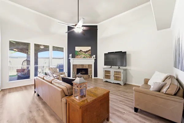 a living room with furniture a flat screen tv and a fireplace