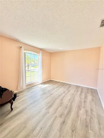 a view of an empty room and wooden floor