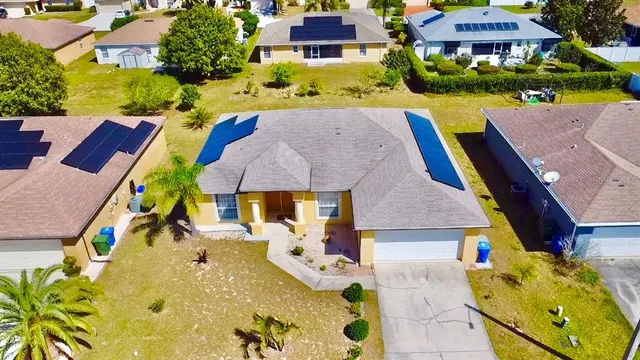 an aerial view of a house with swimming pool and porch