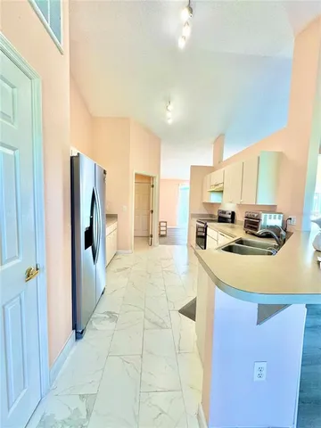 a kitchen with stainless steel appliances a refrigerator sink and cabinets