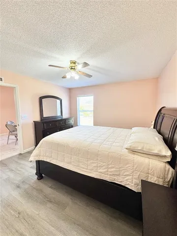 a bedroom with a bed and lamps