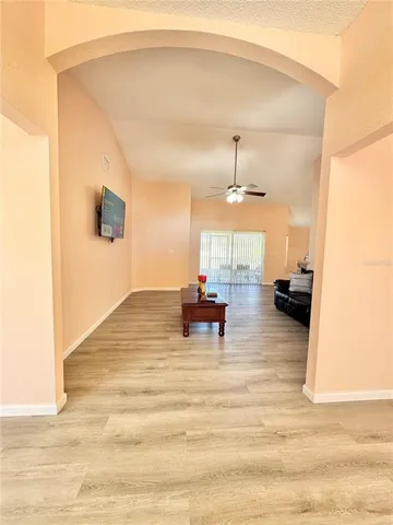 a living room with furniture and a chandelier