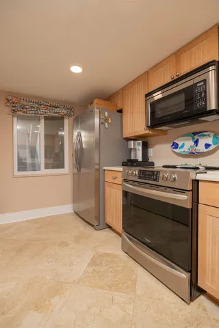 a view of a dining room with furniture and a chandelier