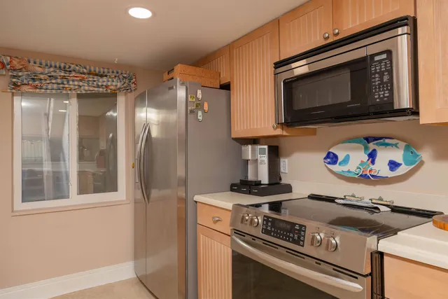a view of a dining room with furniture and a chandelier