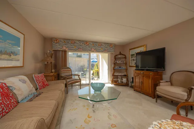 a view of a house with a swimming pool and sitting area