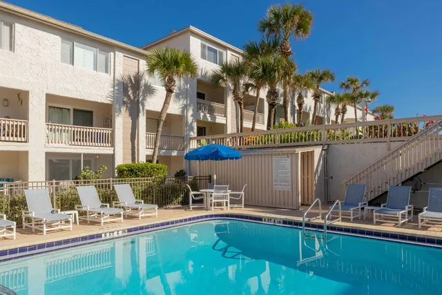 a view of a house with a garden and pathway