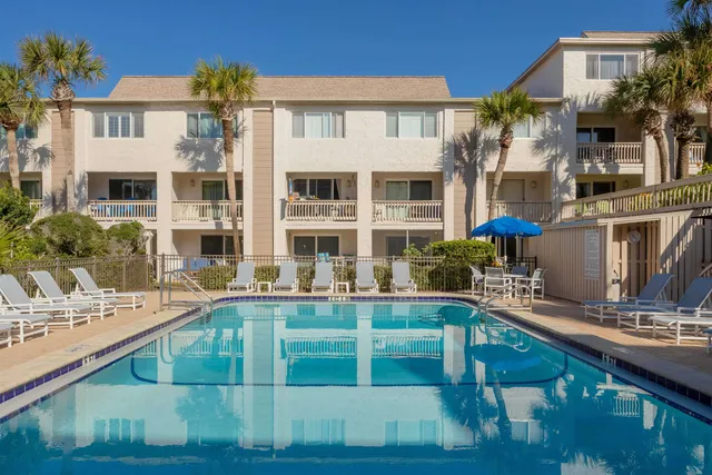 a bedroom with a bed and a potted plant