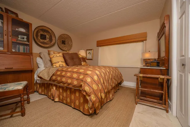 a view of a big building with a big yard and large trees