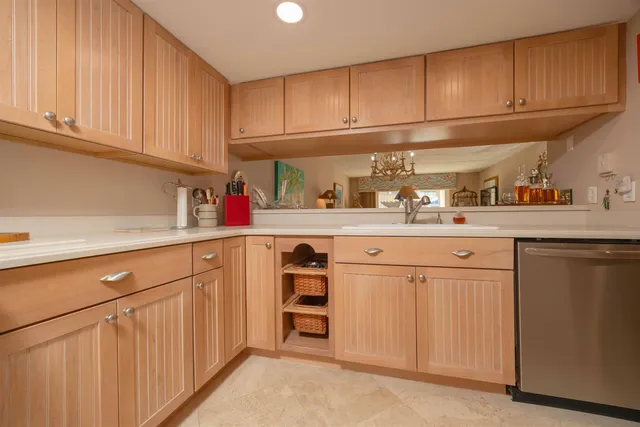 a kitchen with stainless steel appliances a stove a microwave and a sink