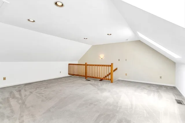 an empty room with a ceiling fan and window