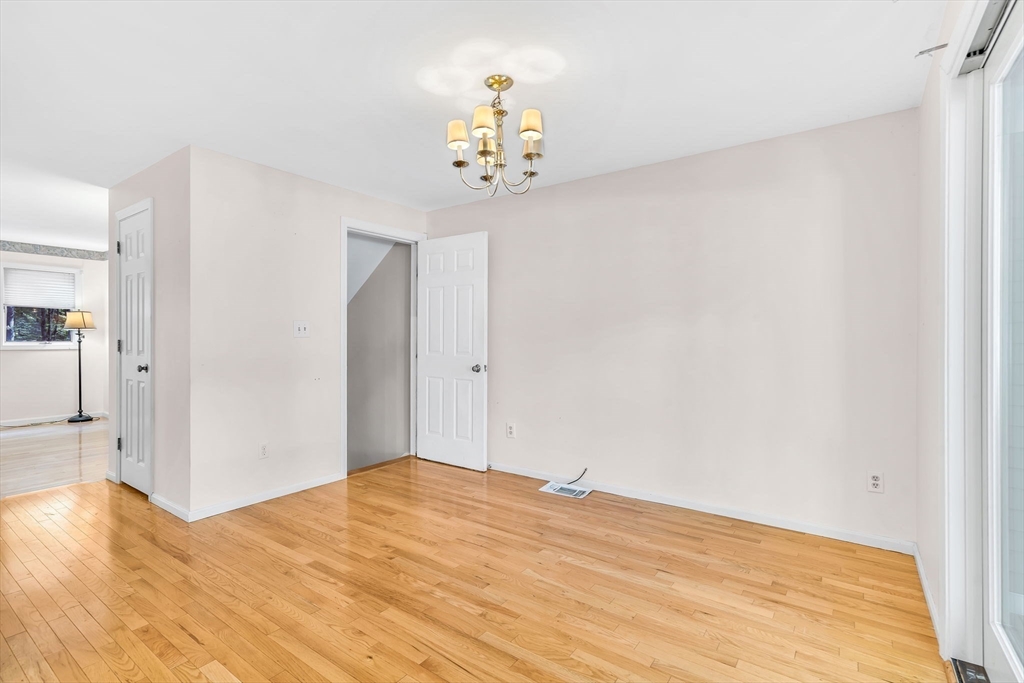 4 Country Meadow Road, Unit 4 Haverhill, MA 01832 - Photo 10 of 29 a bedroom with a bed and a chandelier