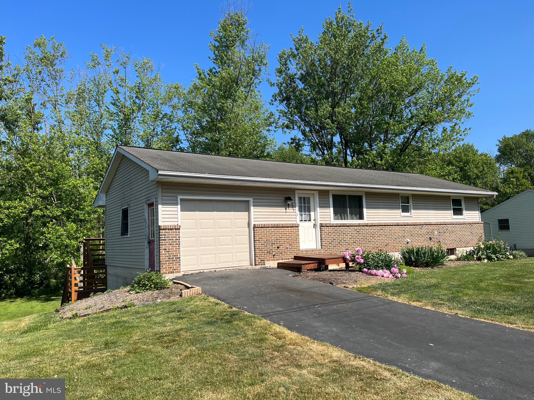 303 Grant Road Adamstown, PA 17569 - Photo 1 of 13 a front view of a house with a yard and garage