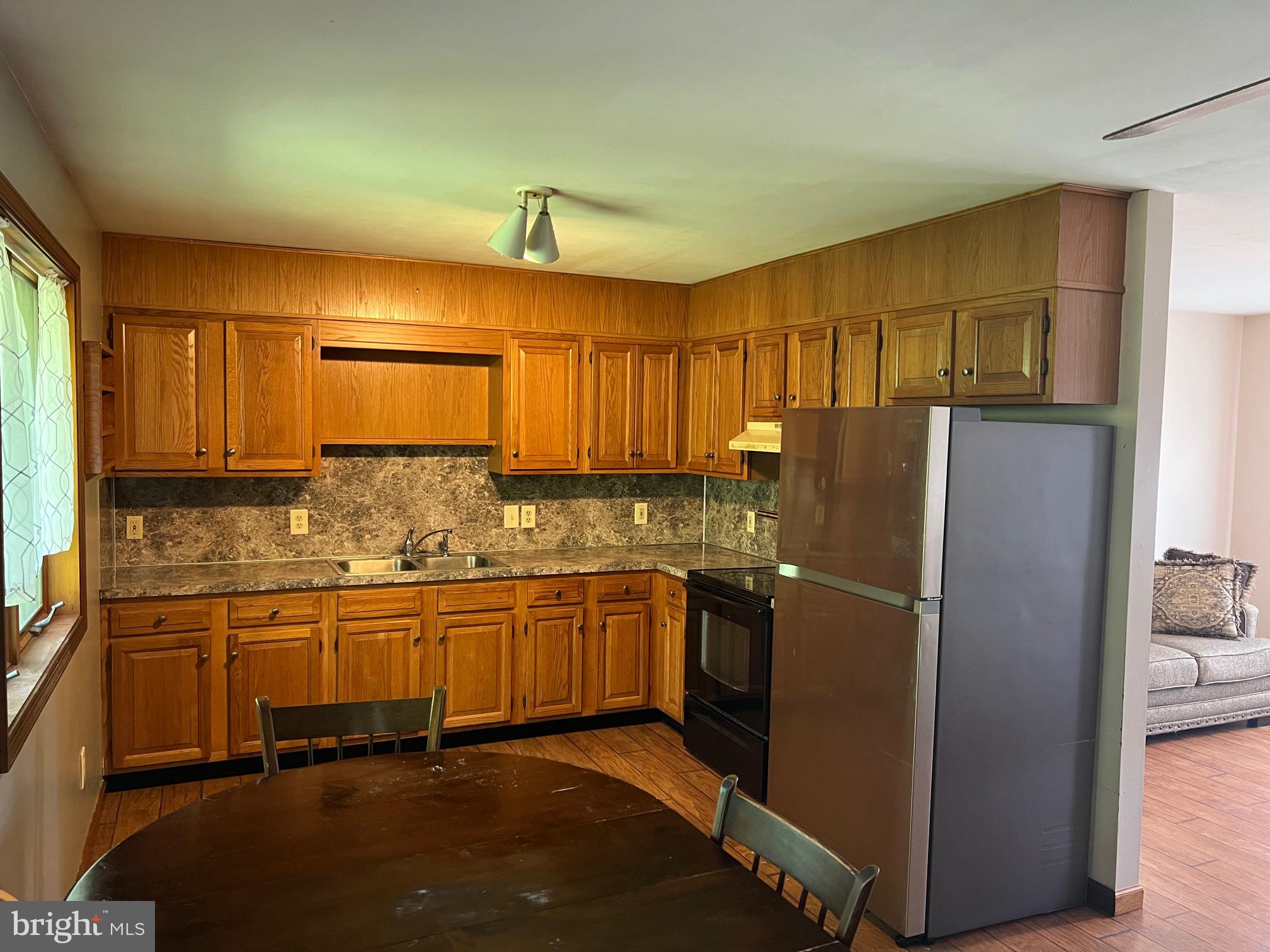 303 Grant Road Adamstown, PA 17569 - Photo 3 of 13 a kitchen with stainless steel appliances granite countertop a refrigerator and a sink