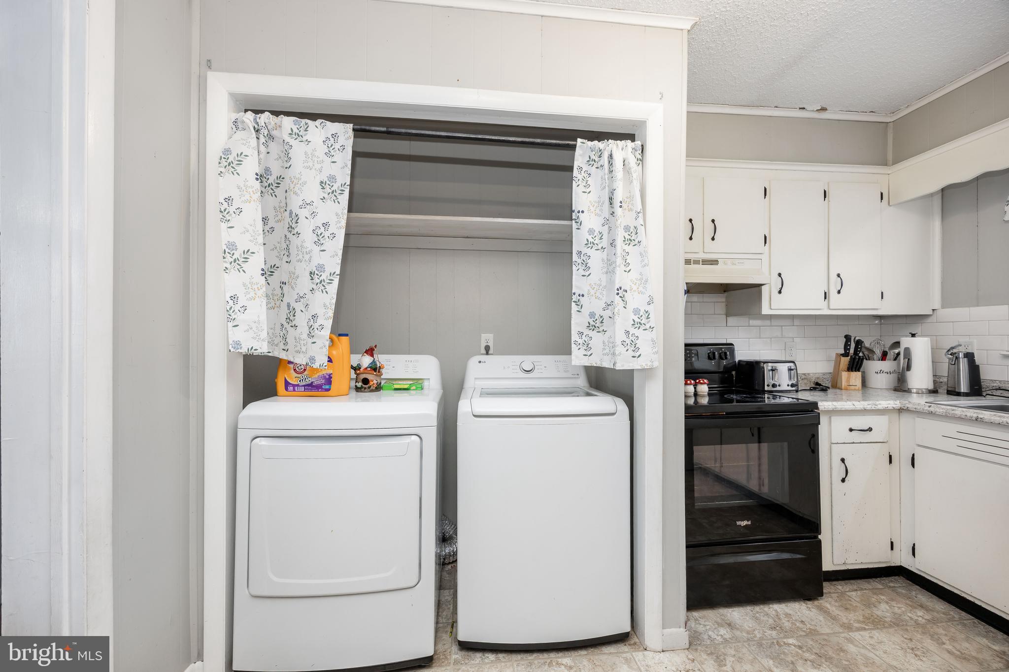6870 Zion Church Road Salisbury, MD 21804 - Photo 18 of 39 a view of washer and dryer with kitchen in the background