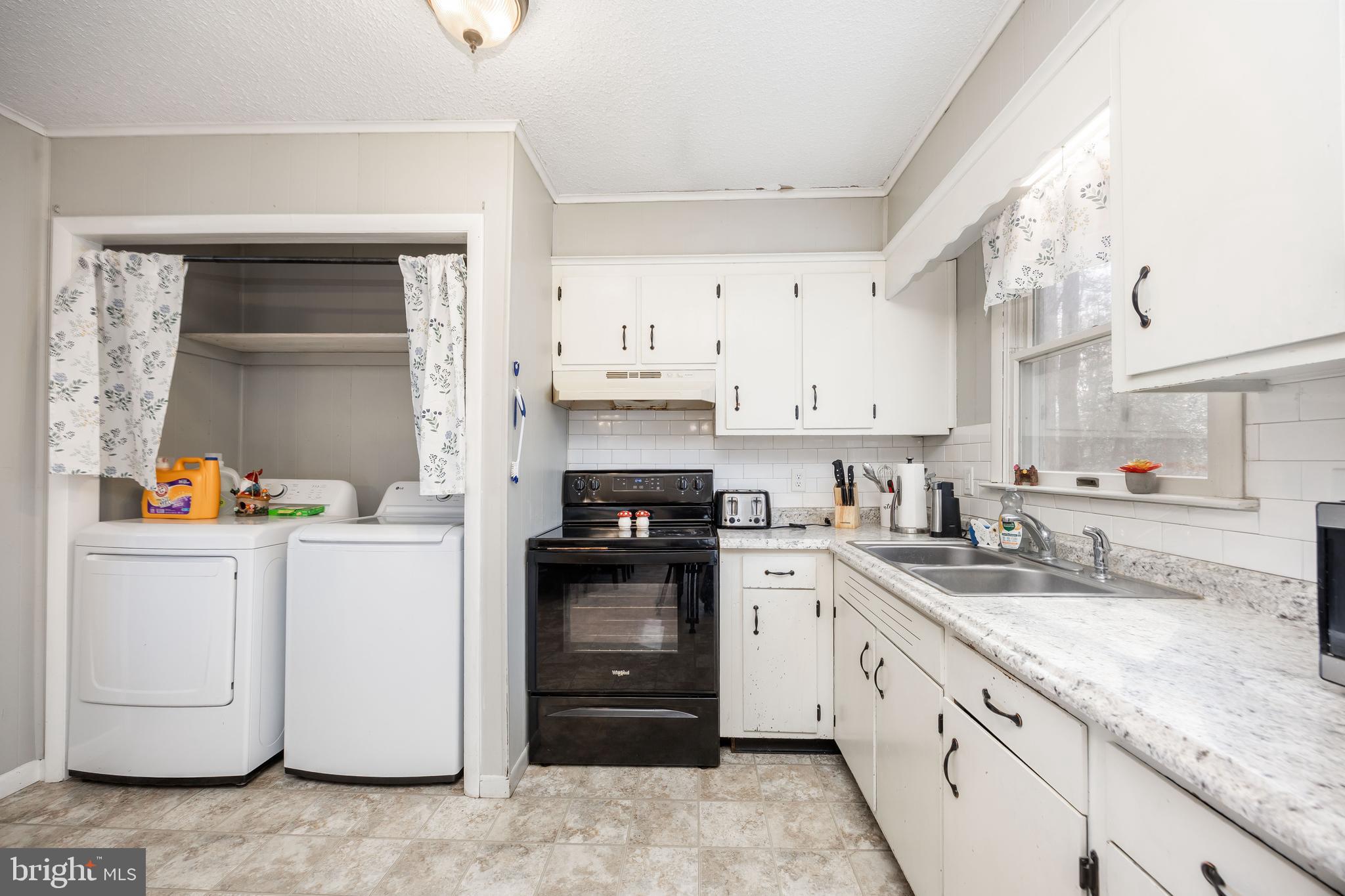 6870 Zion Church Road Salisbury, MD 21804 - Photo 19 of 39 a kitchen with granite countertop white cabinets and white appliances