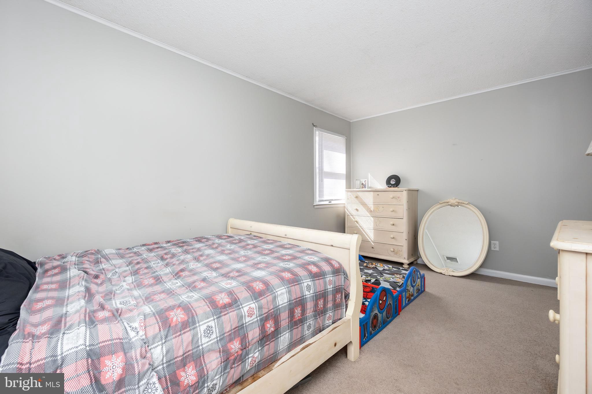 6870 Zion Church Road Salisbury, MD 21804 - Photo 25 of 39 a bed sitting in a bedroom next to a window with tv and wooden floor